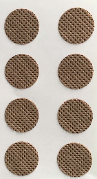 Close-up photo of 8 round brown transdermal supplement patches on white backing sheet